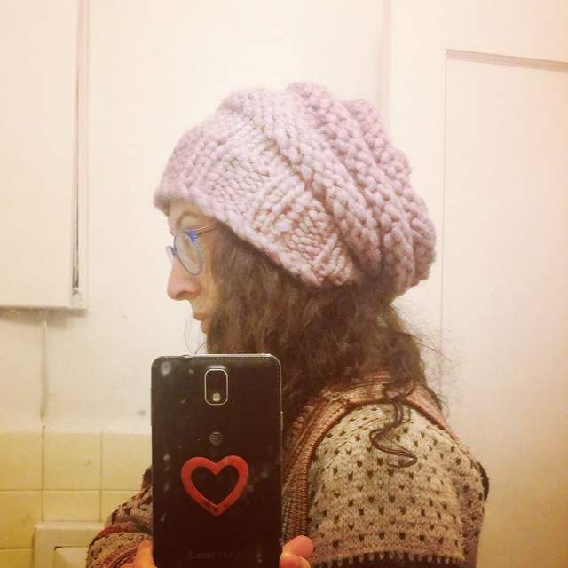 A woman modeling a knit hat