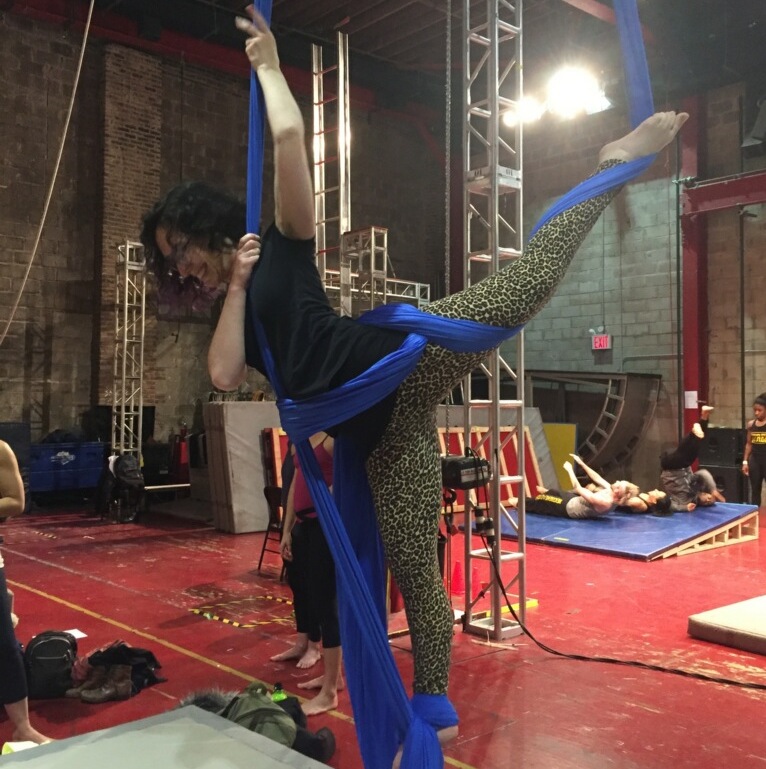 A woman performing an acrobatic maneuver