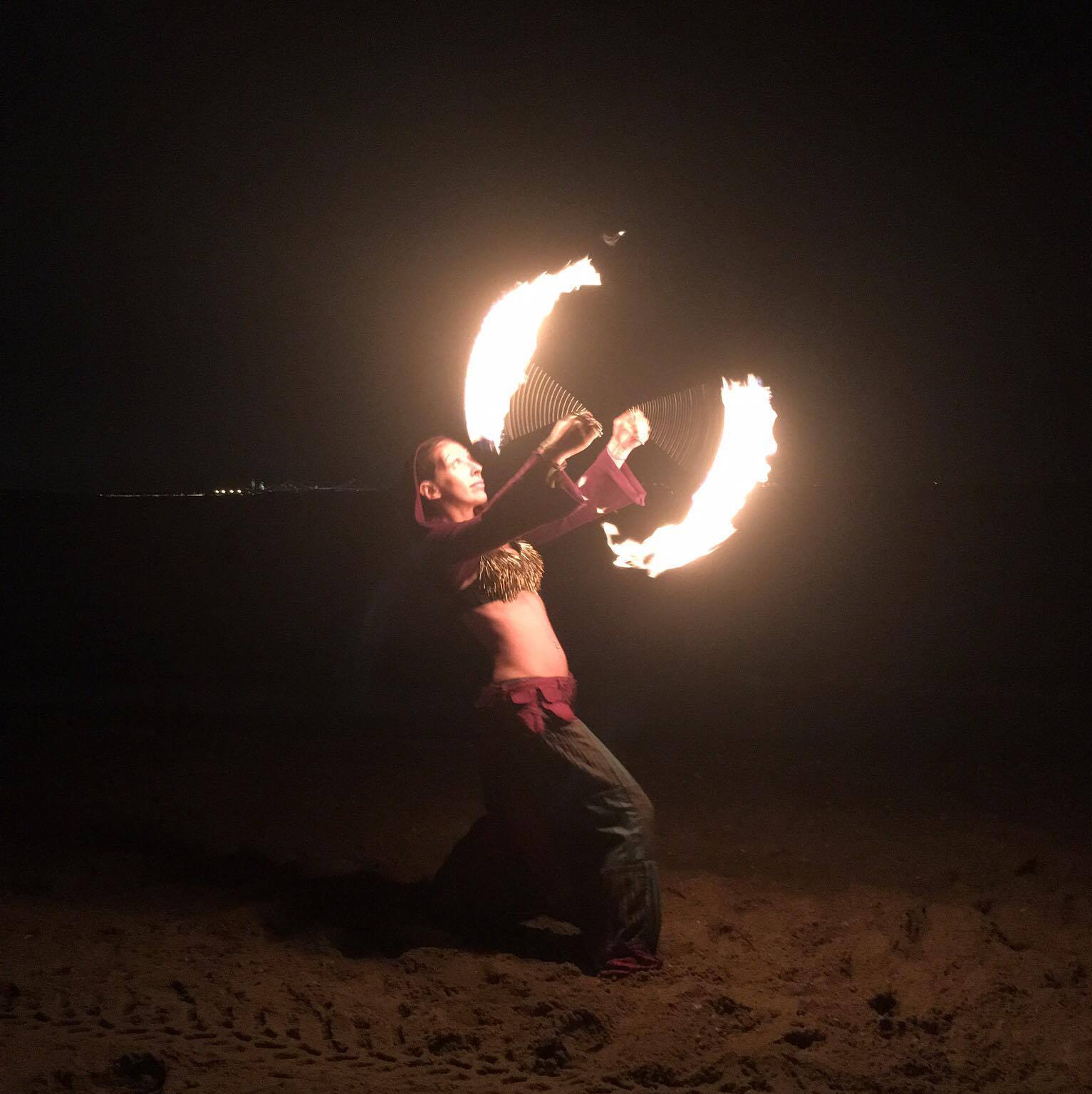 A fire spinner performing